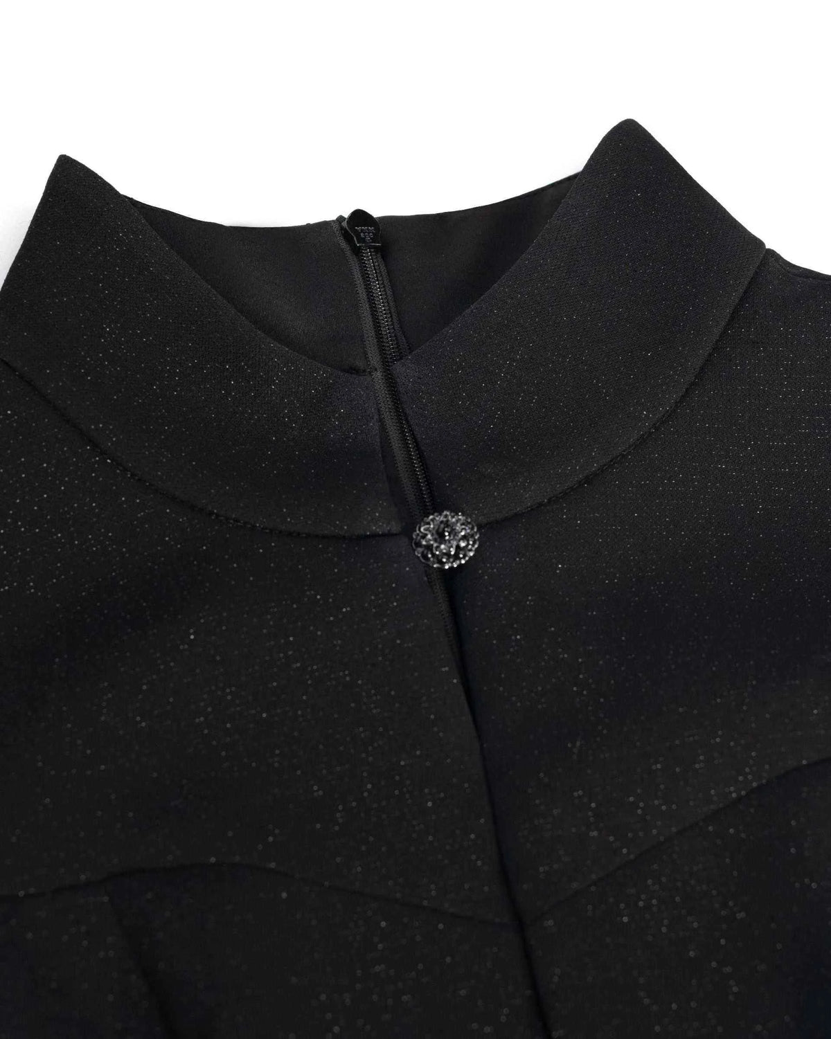 The upright collar meets a small decorative fastening above the front opening.