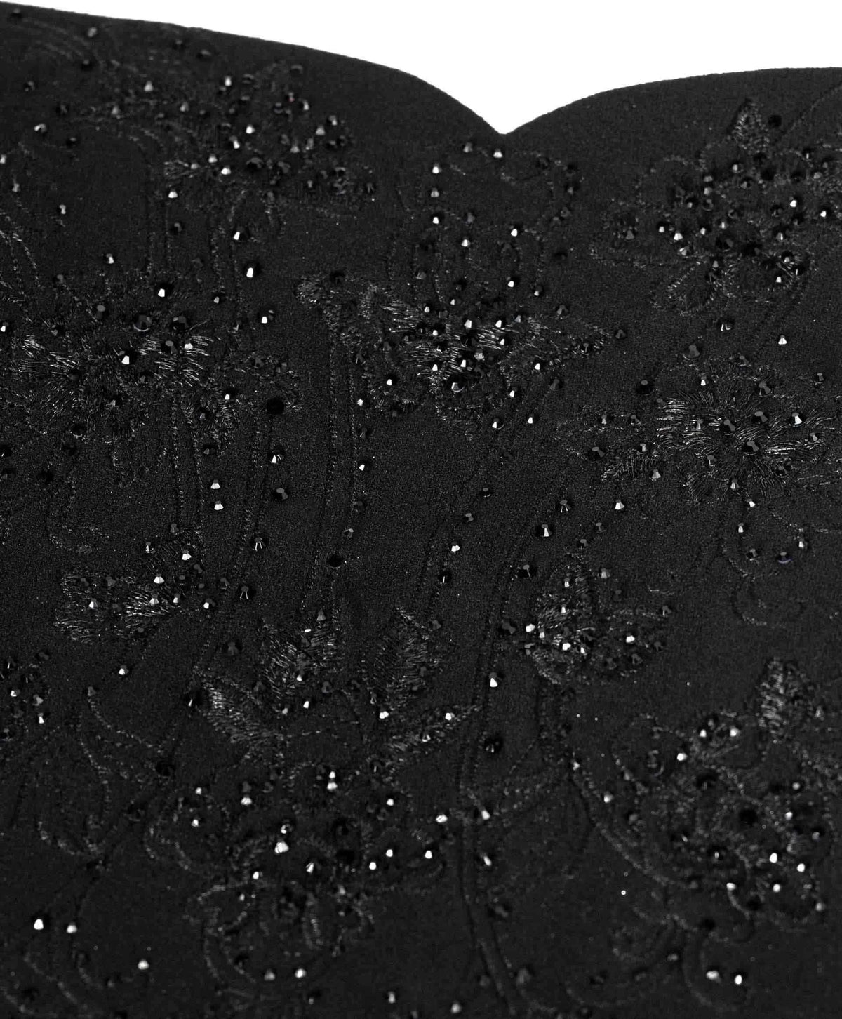 Small dark decorative accents form a textured surface near the upper edge.