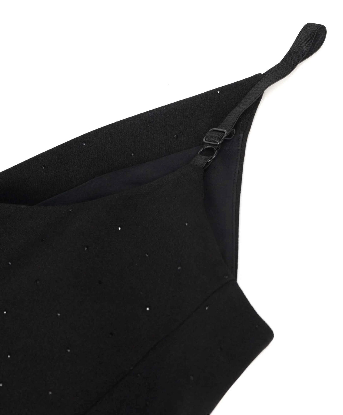 A narrow strap rises from the shaped upper edge, keeping the shoulder line light.