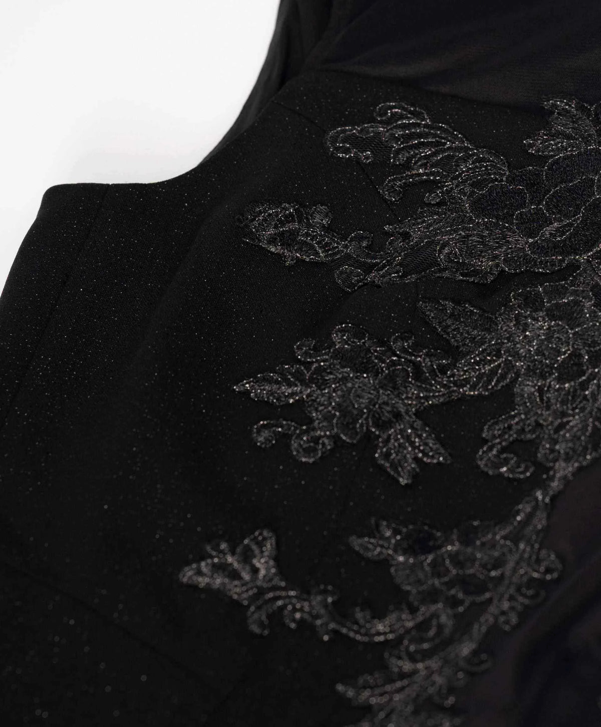 The floral detail continues towards the upper edge and shoulder, keeping the decoration concentrated around the bodice.
