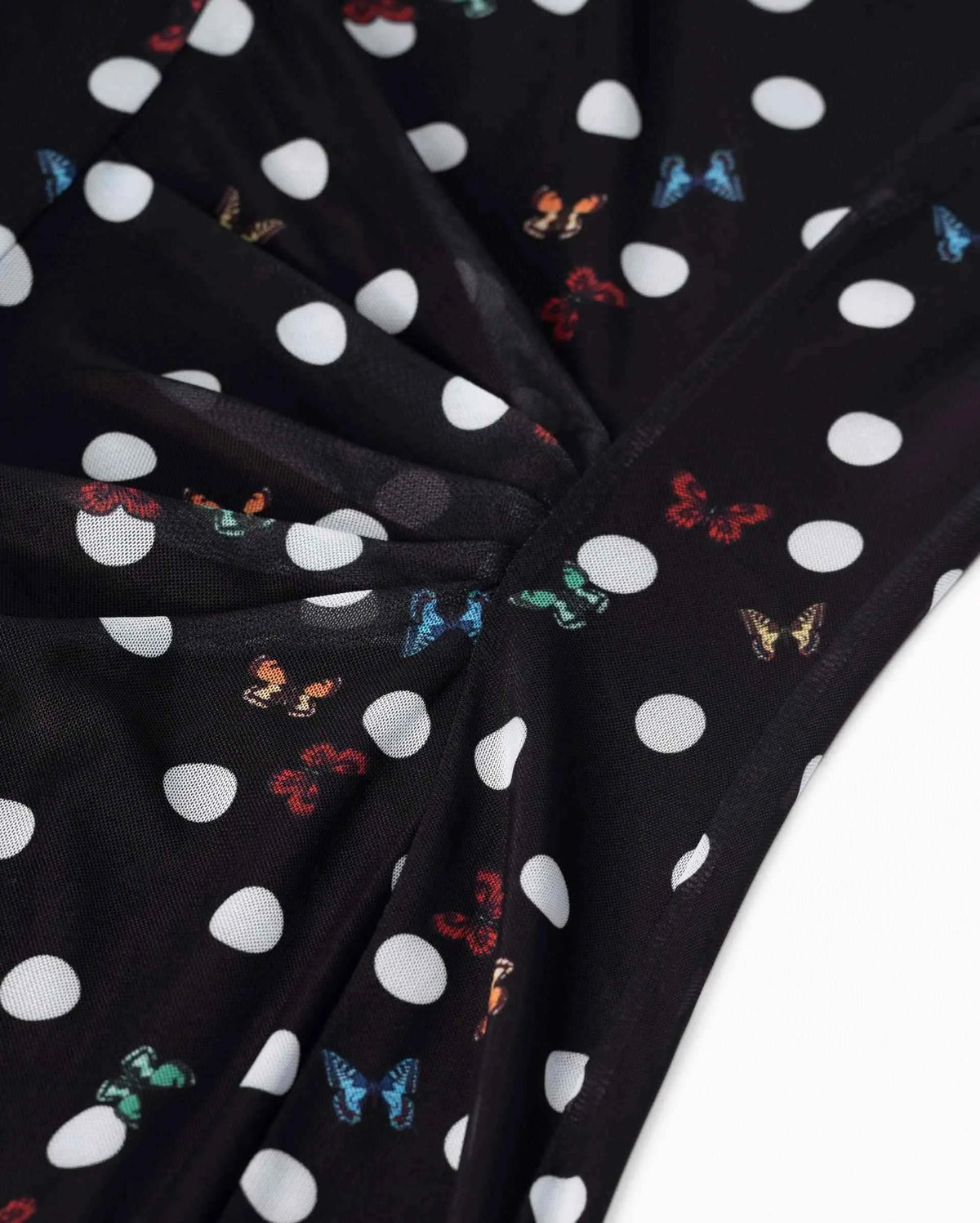 The fabric gathers into close folds around the waist, creating a clear centre within the dress.