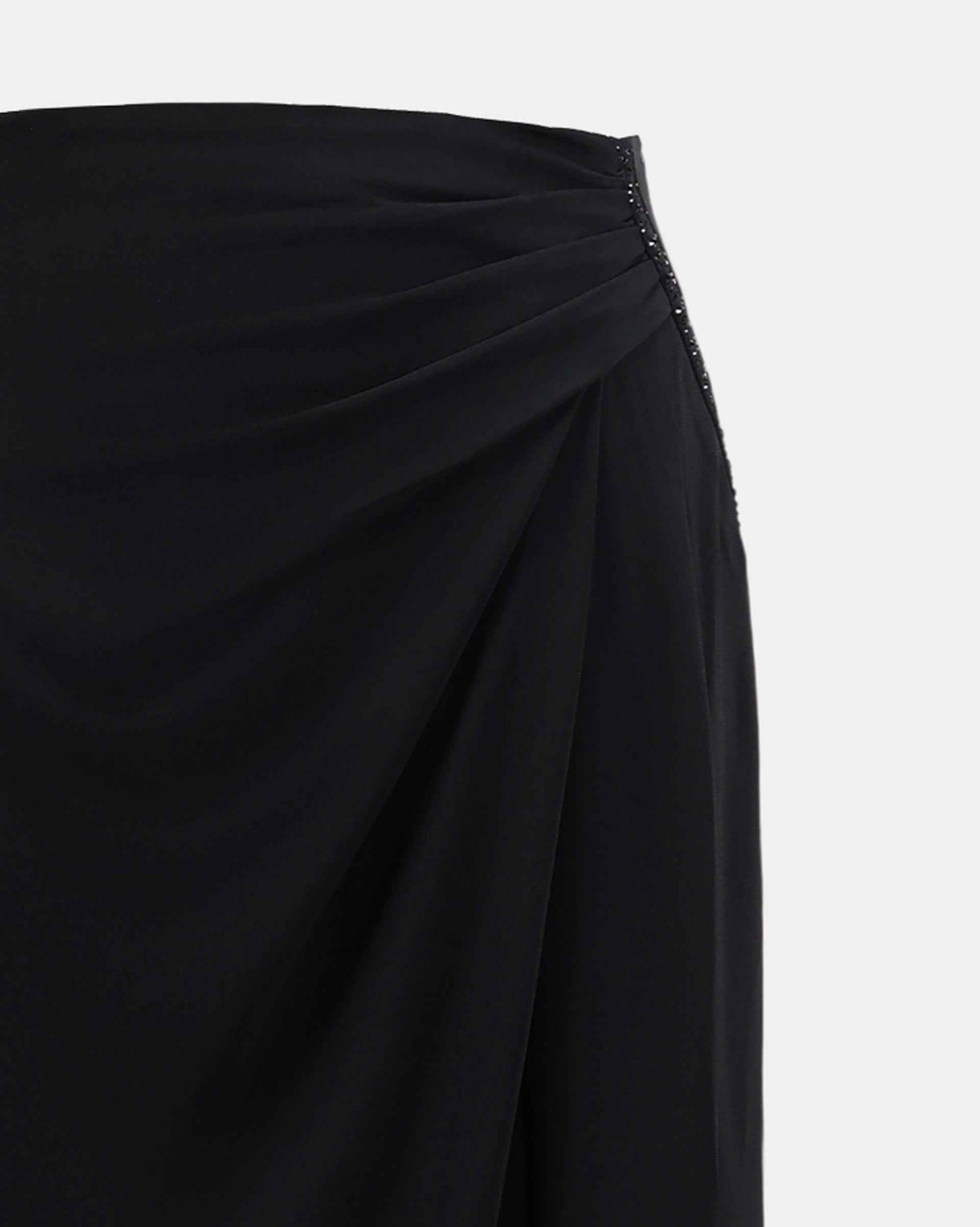 Diagonal folds gather across the upper skirt, giving the waist and hip a softly draped appearance.