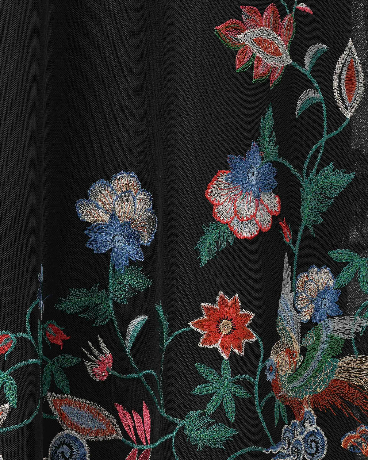 Colourful flowers and trailing stems rise through the dark fabric, separated by open areas of black.