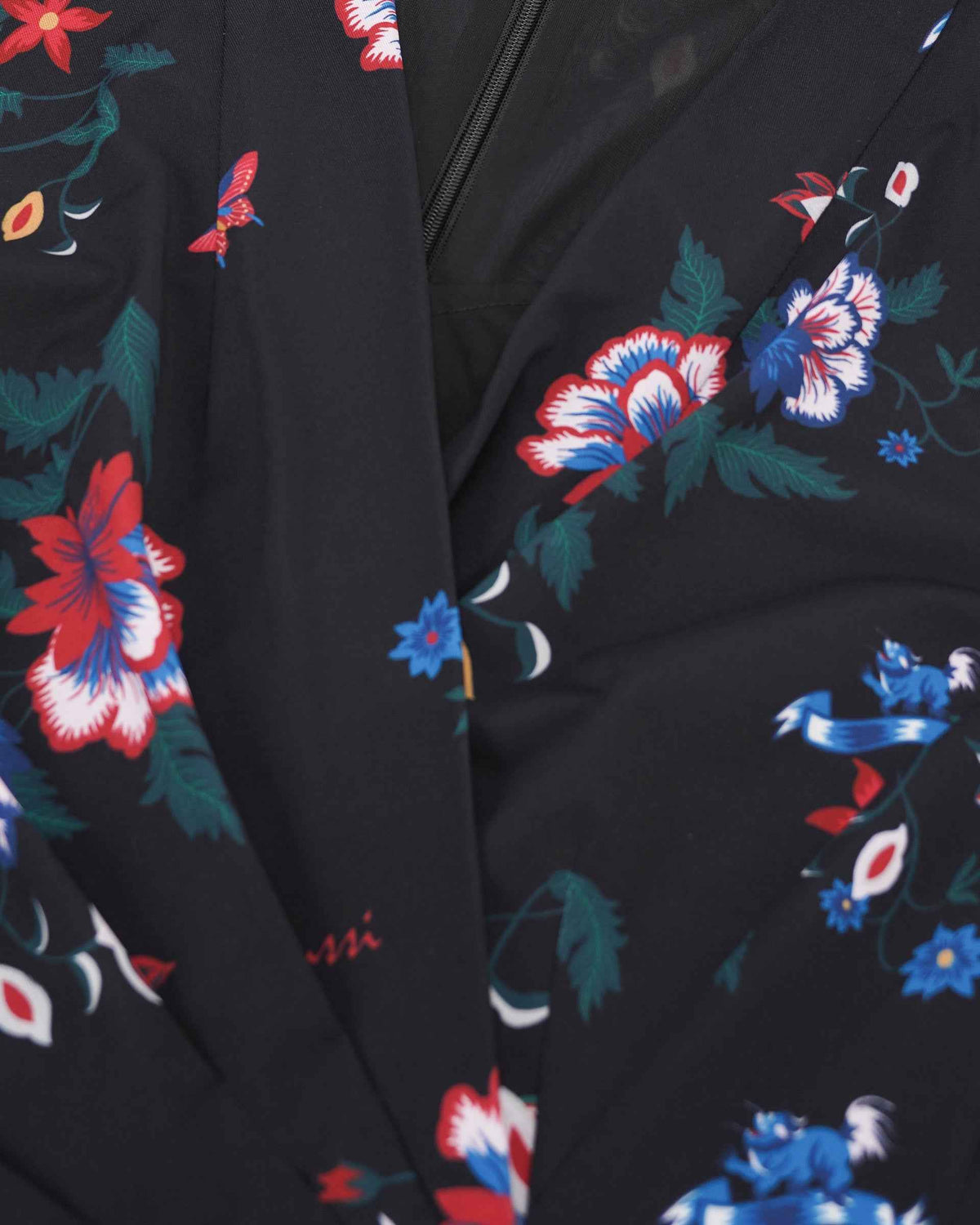 The neckline and front edge give the blouse a clear, tailored frame.