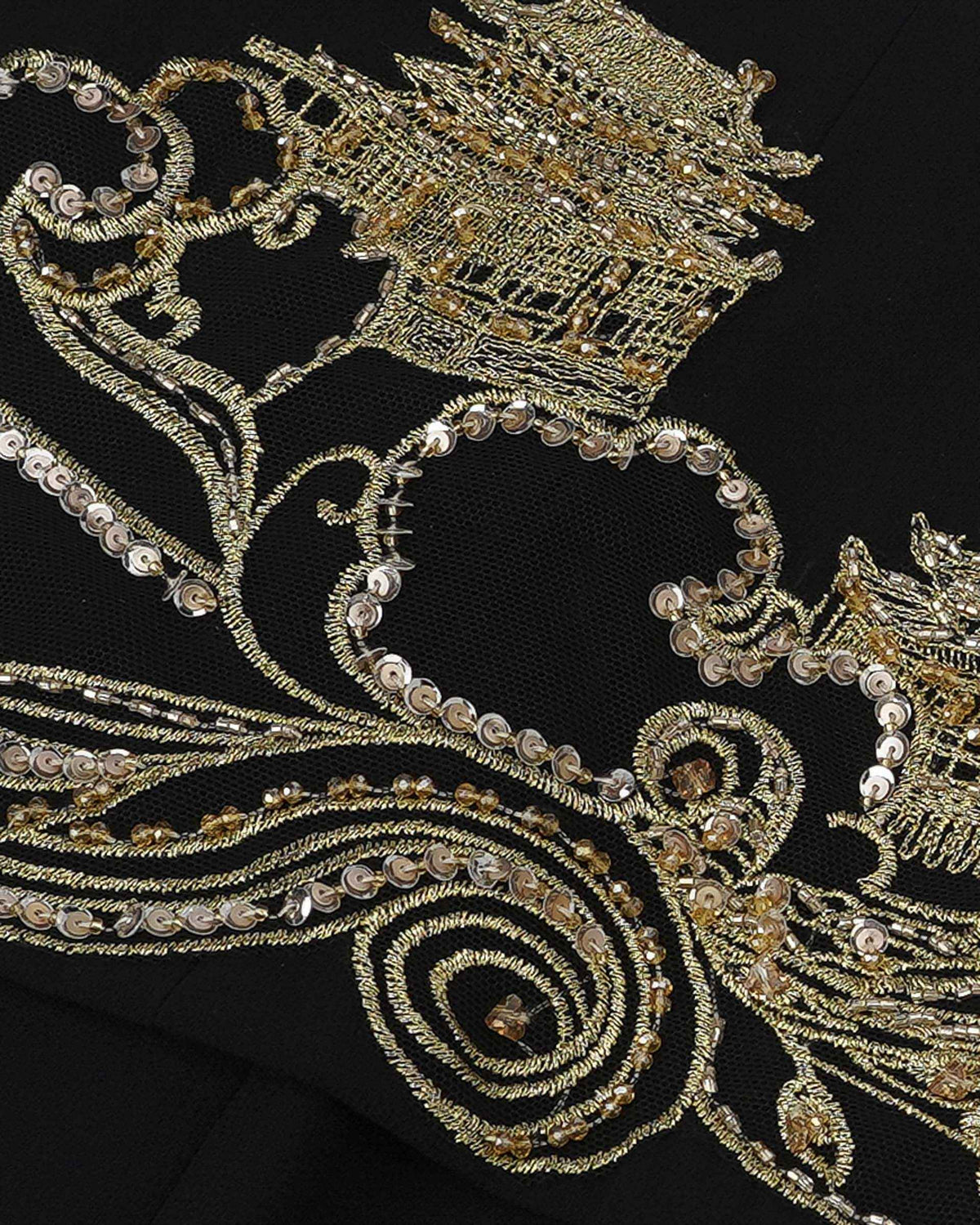 A tower-like motif sits among curling embroidered lines on the black ground.