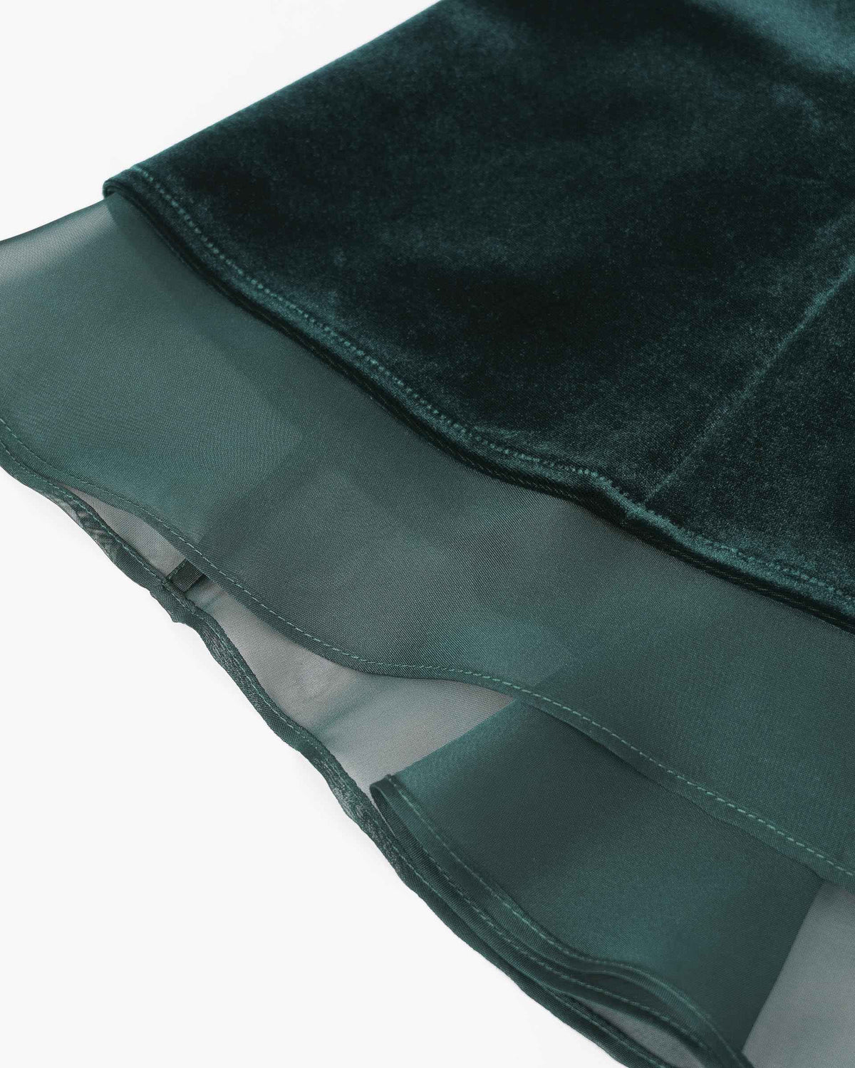 The deep green velvet ends above a transparent layer in a related tone.