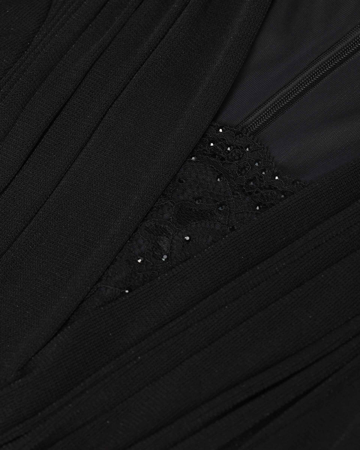 A dark embellished detail sits between diagonal folds, creating a subtle point of interest.