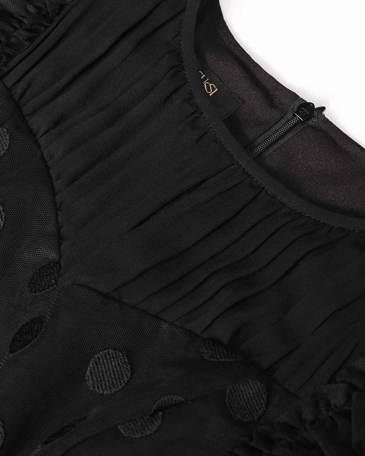 Small gathers sit beneath the rounded neckline and continue into the upper body.
