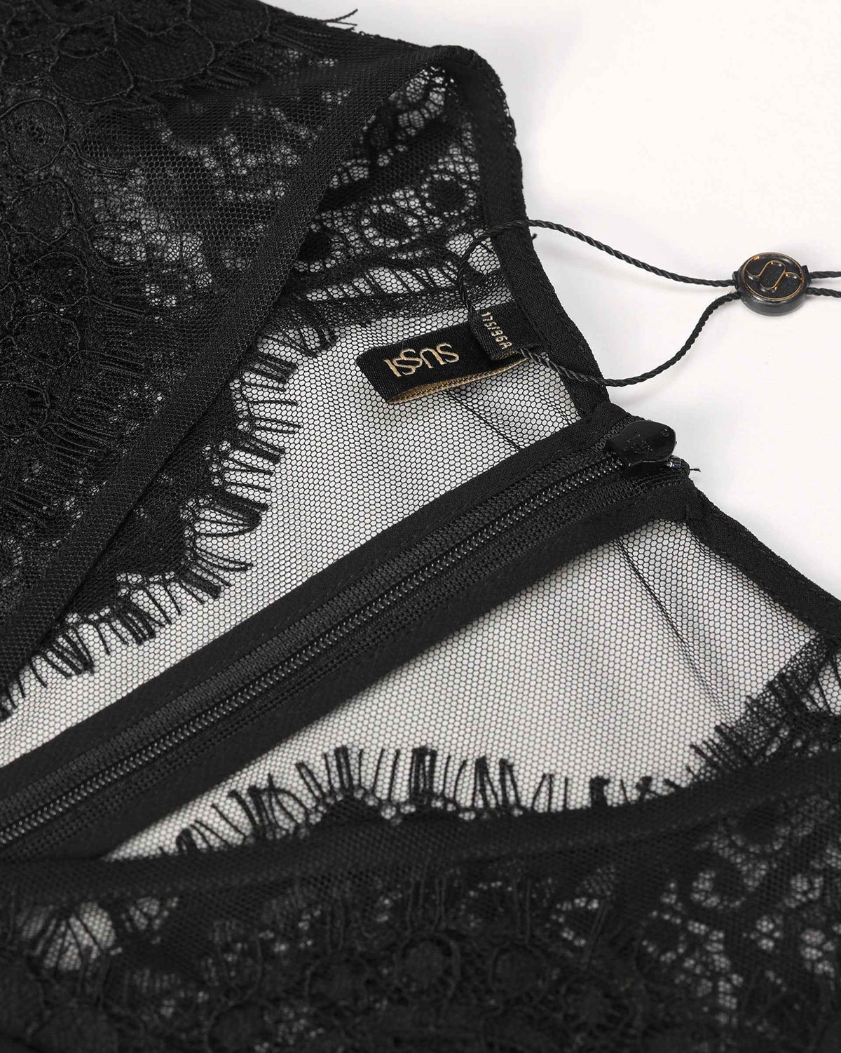 Floral lace surrounds the small opening below the upright collar.