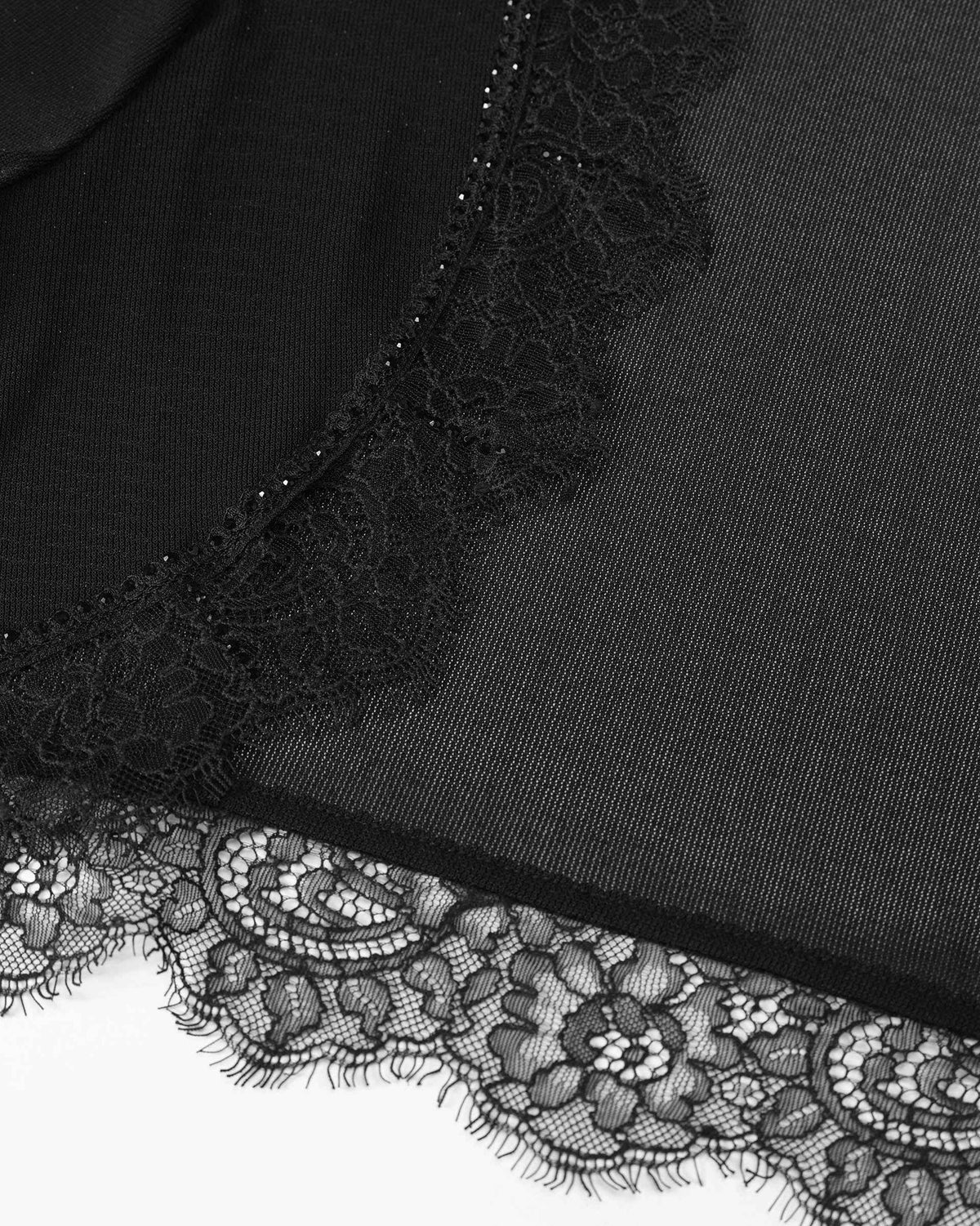 Floral lace traces the open front and lower edge of the bolero.