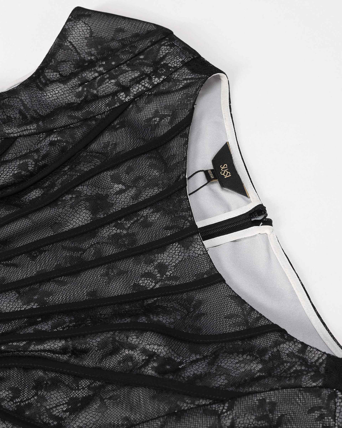 Floral lace sits beside the upper opening, with a narrow fastening visible at the edge.