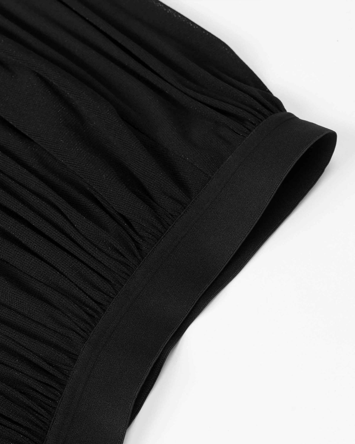 Closely spaced gathers start beneath the elasticated waistband and open into broader folds below.