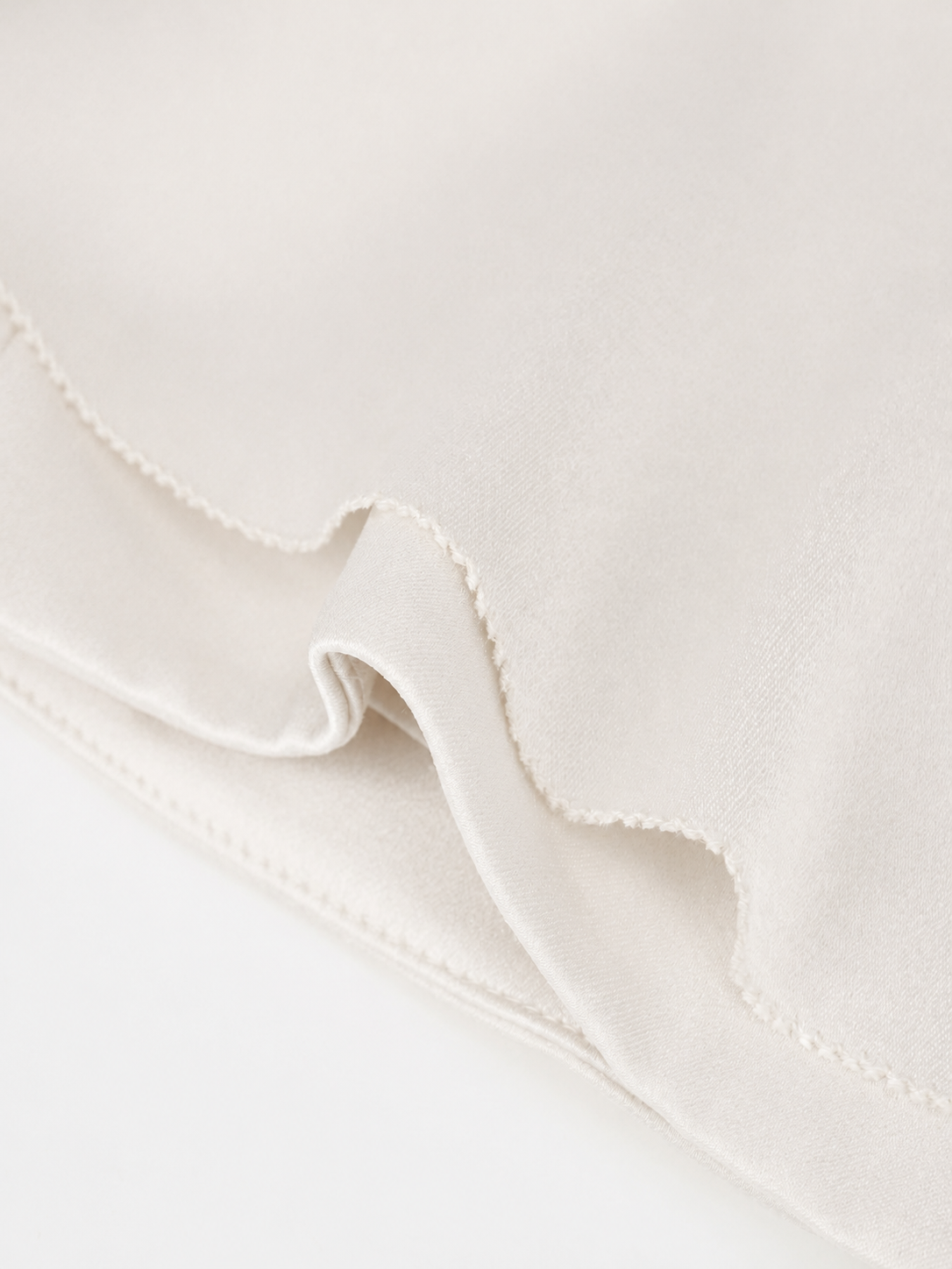 The close-up reveals overlapping ivory edges that curve away from one another.