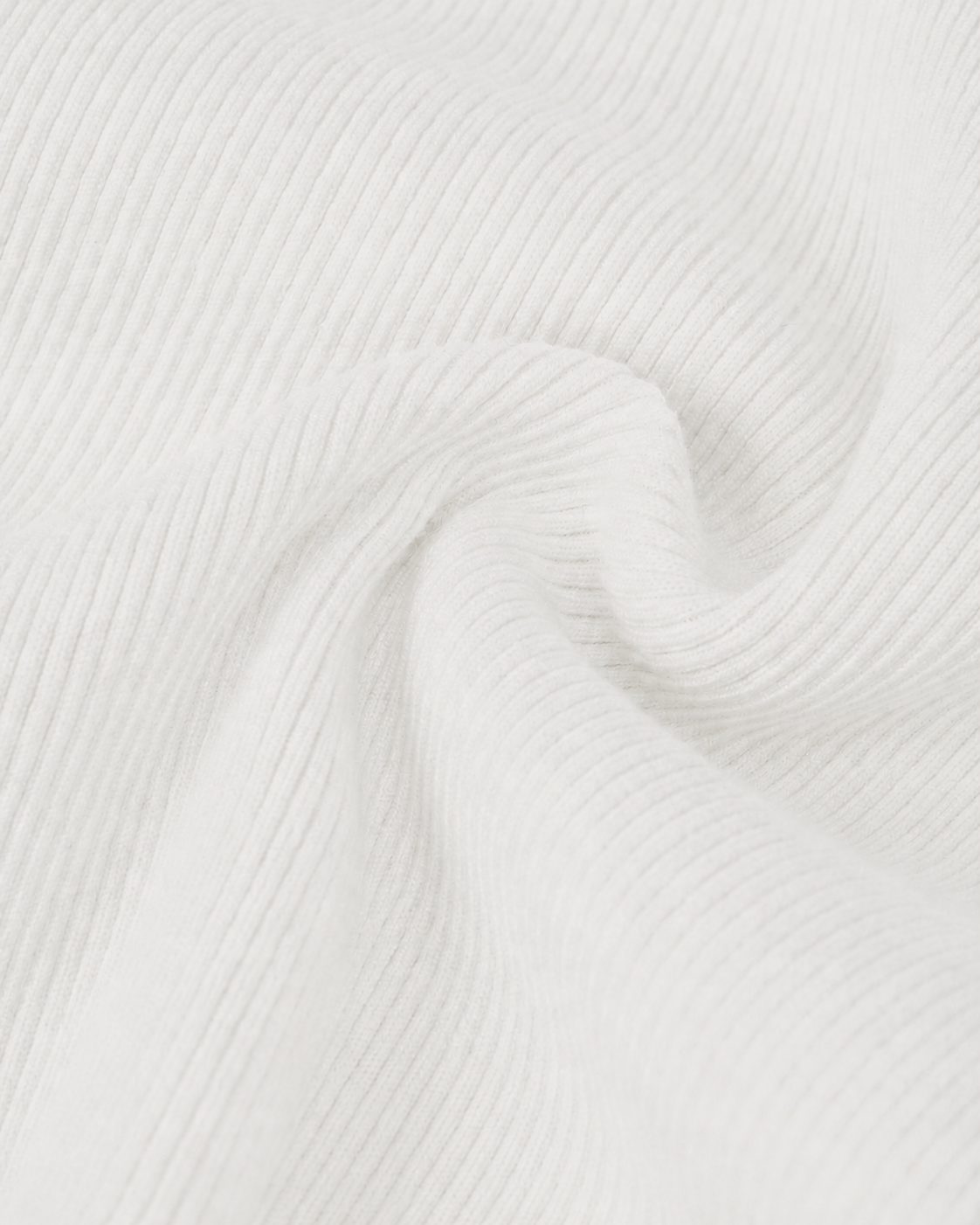 The close-up reveals fine ribs running through the pale knit as it gathers into folds.