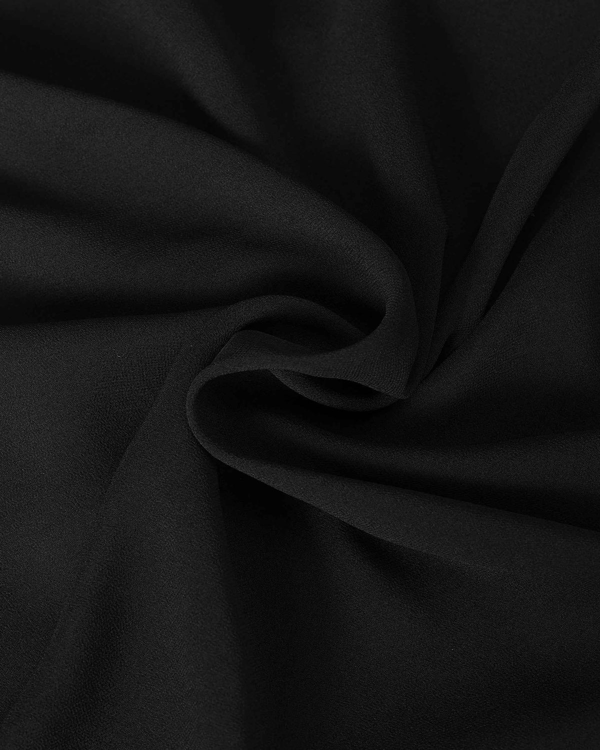 The dark fabric forms broad, smooth folds, revealing gentle differences in light across its surface.