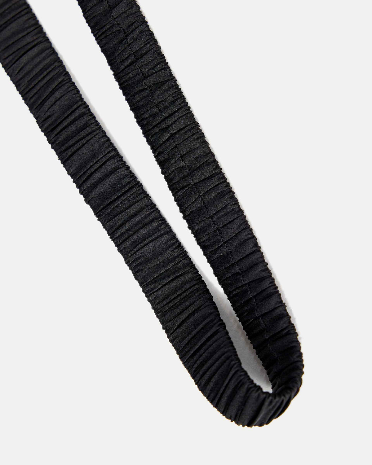 Closely spaced gathers run along the dark band, creating a fine repeated texture.