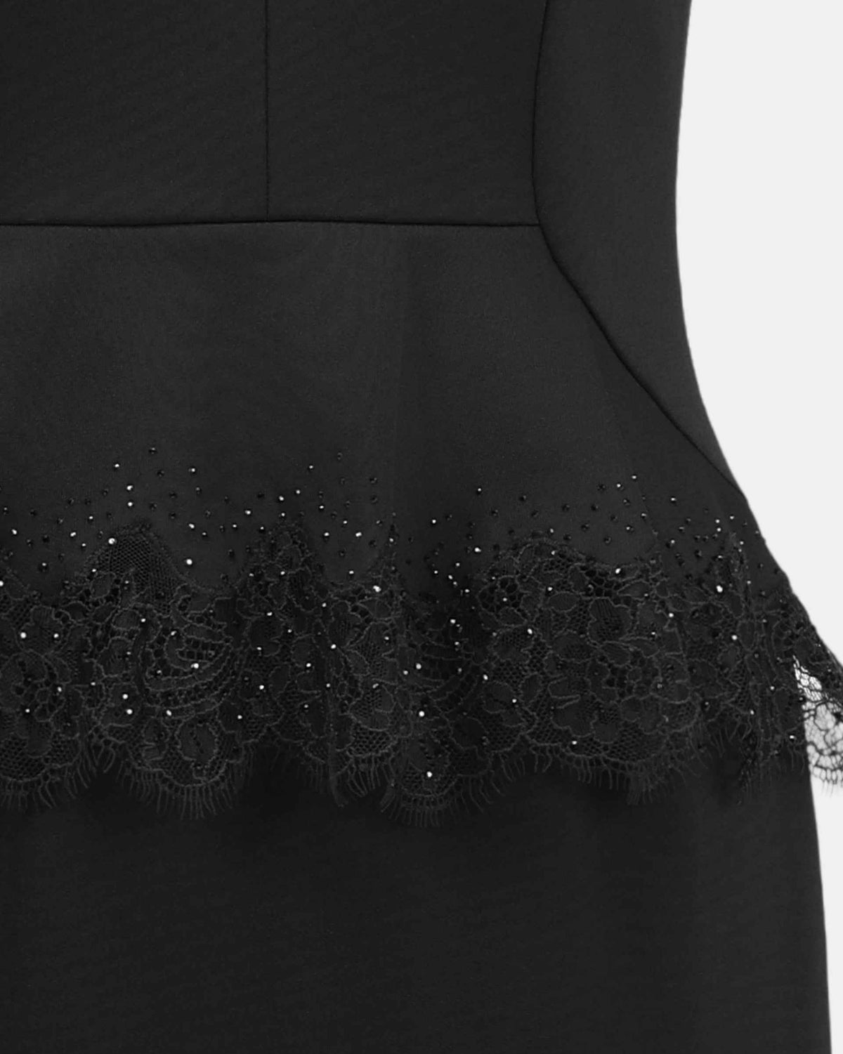 A lace border follows the edge of the shaped layer at the waist.