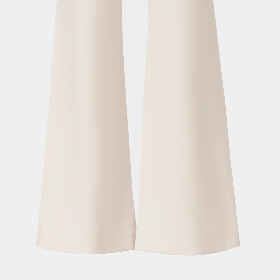 The back legs widen gently towards their hems through smooth ivory fabric.