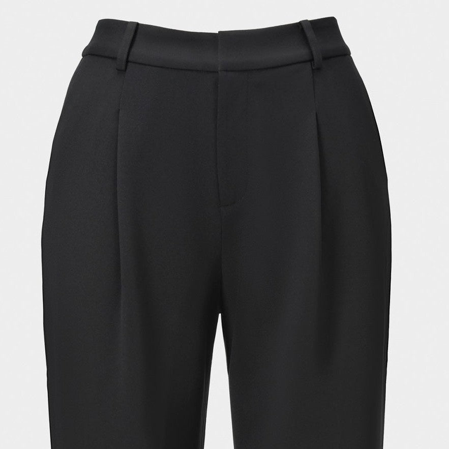 The close view reveals a simple waistband and clean lines through the upper trousers.