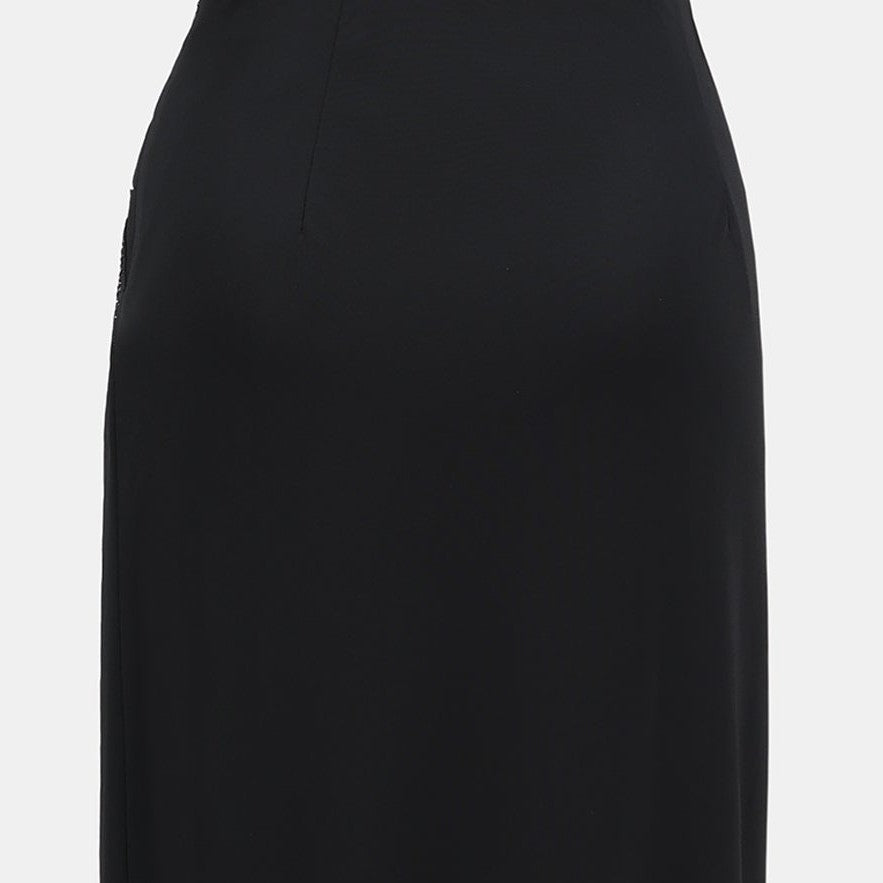 The close back view keeps a clean line through the waist and hip, balancing the more gathered front.